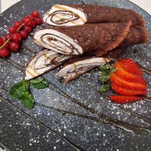 Chocolate pancakes with whipped cream